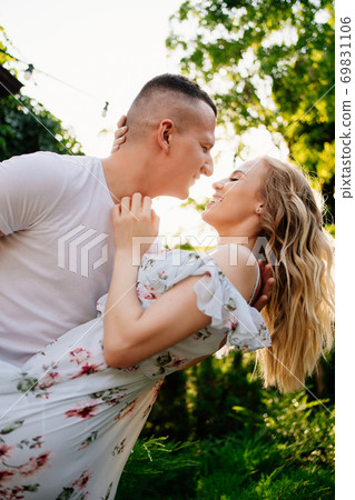 beautiful and happy couple having fun in garden. beautiful and happy couple having fun in garden. 69831106