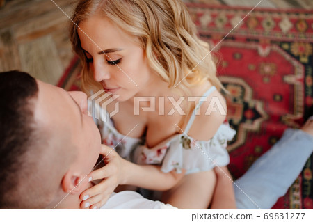 lovers are sitting in front fireplace. close up. lovers are sitting in front fireplace. close up. 69831277