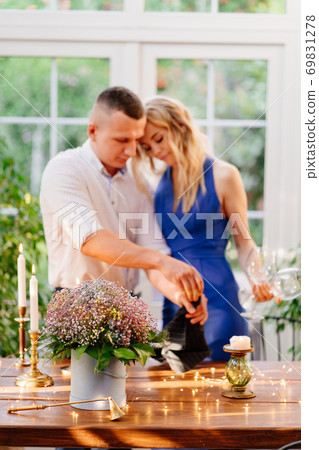 couple on romantic dinner. guy pours champagne. couple on romantic dinner. guy pours champagne. 69831278