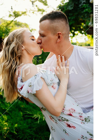 beautiful and happy couple having fun in garden. beautiful and happy couple having fun in garden. 69831281