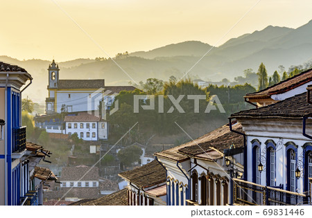 Facades of houses and church in colonial architecture in an old street in the city of Ouro Preto 69831446