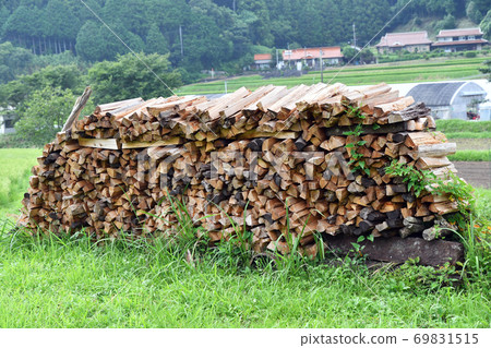 Firewood burning wood lined up 69831515