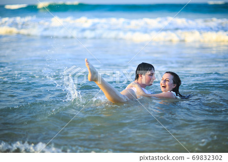man and woman swim in sea and having fun. man and woman swim in sea and having fun. 69832302