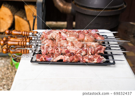 raw meat on skewers for cooking kebabs on grill. raw meat on skewers for cooking kebabs on grill. 69832437