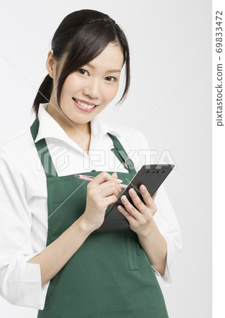 Female employee listening to orders Female employee listening to orders 69833472