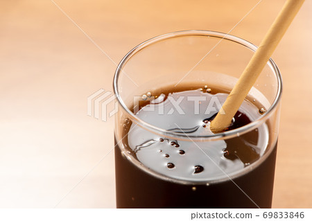 Coke with a paper straw. 69833846