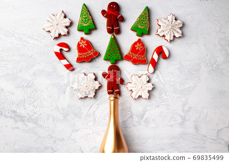 Golden champagne bottle with Christmas gingerbread flatlay Golden champagne bottle with Christmas gingerbread flatlay 69835499