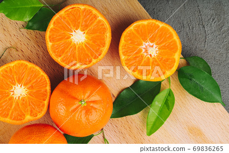 Sliced into pieces juicy ripe oranges close up Sliced into pieces juicy ripe oranges close up 69836265