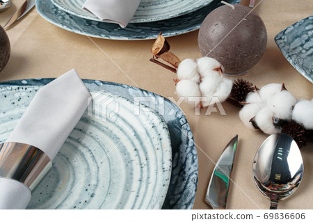 Beautiful table setting decorated with cotton buds Beautiful table setting decorated with cotton buds 69836606