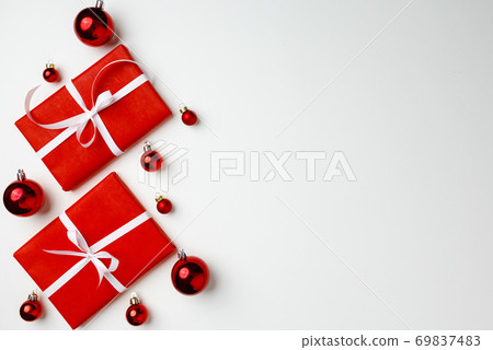 Red gift boxes and Christmas baubles on white background Red gift boxes and Christmas baubles on white background 69837483