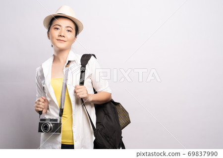 Happy woman holding camera over background and looking at camera 69837990
