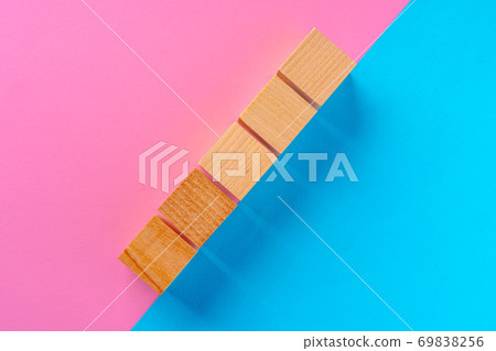 Top view photo of wooden blocks on pink and blue 69838256