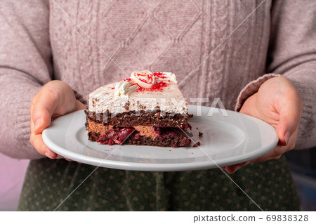 Chocolate cake with whipped cream icing on plate Chocolate cake with whipped cream icing on plate 69838328