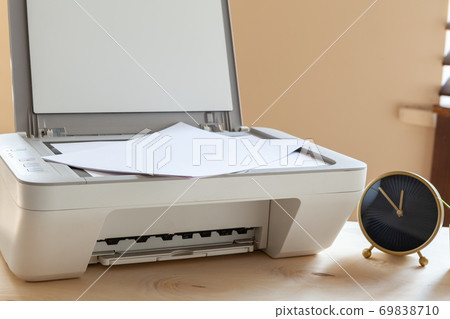White scanner or printer machine on a table close up White scanner or printer machine on a table close up 69838710