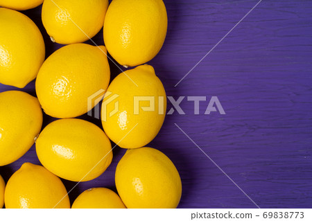 Top view of lemon on purple wooden background Top view of lemon on purple wooden background 69838773