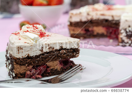 Chocolate cake with whipped cream icing on plate Chocolate cake with whipped cream icing on plate 69838774