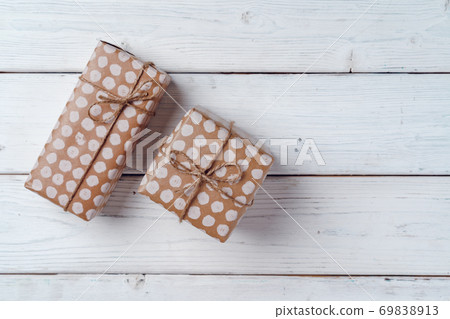 Wrapped Christmas gifts on white wooden board, top view Wrapped Christmas gifts on white wooden board, top view 69838913