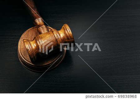 Judge's gavel on wooden table in dark Judge's gavel on wooden table in dark 69838968
