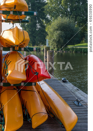 Colorful kayaks on the lake outdoor on a summer day Colorful kayaks on the lake outdoor on a summer day 69838990