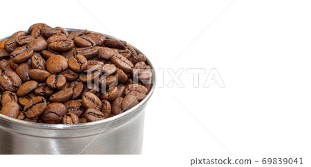 A lot of coffee beans in a metal coffee grinder on a white background 69839041
