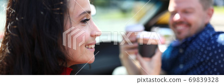 Woman and man are drinking coffee and smiling. Woman and man are drinking coffee and smiling. 69839328