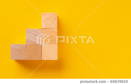 Top view of wooden cubes on yellow Top view of wooden cubes on yellow 69839920