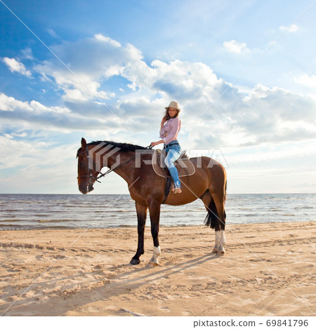 girl with horse on seacoast 69841796