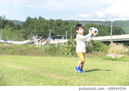 A boy with a soccer ball A boy with a soccer ball 69844204