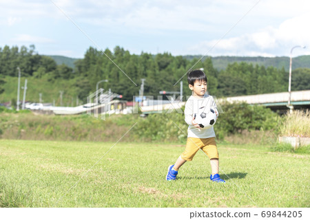 A boy with a soccer ball 69844205