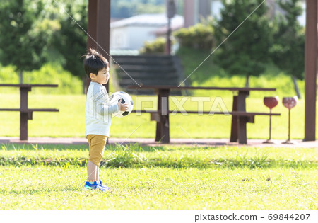 A boy with a soccer ball 69844207