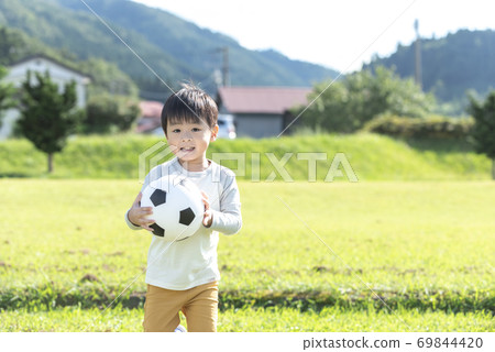 A boy with a soccer ball A boy with a soccer ball 69844420