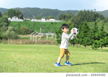 Boy throwing a soccer ball Boy throwing a soccer ball 69844480