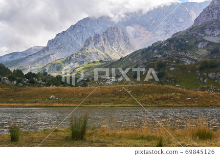 alpine lake with a high mountain range in the background 69845126