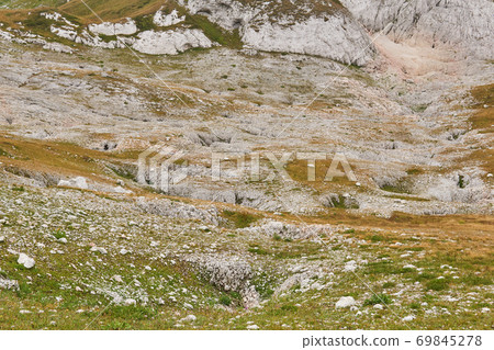 beautiful mountain slope covered with sinkholes 69845278