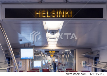 A digital information board in the train announces stations. A digital information board in the train announces stations. 69845442