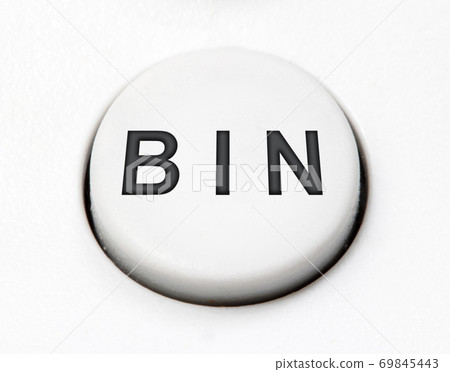 A white round button switch - bin, close up. Control mechanical key for delete on control device. A white round button switch - bin, close up. Control mechanical key for delete on control device. 69845443