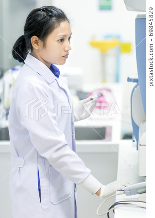 doctor working with Hematology analyzer machine doctor working with Hematology analyzer machine 69845829