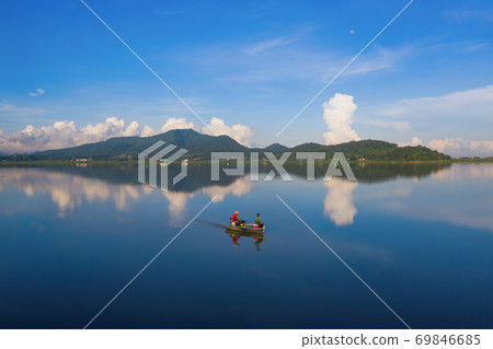 Fisherman with boat in Bang Pra Reservoir dam. National park with reflection of river lake, mountain valley hills in Sri Racha, Chonburi, Thailand in travel trip. Natural landscape background. 69846685