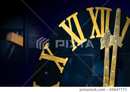 The clock with gilded Roman numerals shows twelve hours. The midnight on tower clock.  69847773