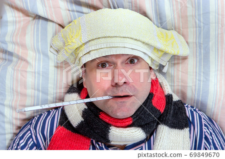 A sick man lying in the bed 69849670