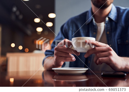 Cropped image of man with beard drinking coffee 69851373