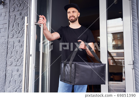 Handsome pizza deliver day time shot Handsome pizza deliver day time shot 69851390