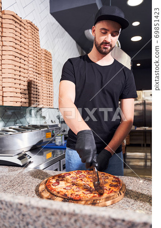 Man cutting italian pizza Man cutting italian pizza 69851423