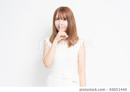 Young woman hiding mouth Young woman hiding mouth 69851440