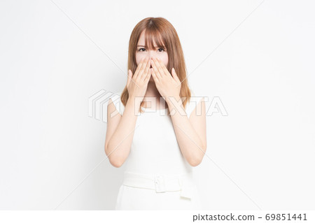 Young woman hiding mouth Young woman hiding mouth 69851441