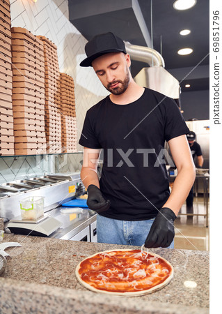 Pizzaiolo with beard making a Pizza Pizzaiolo with beard making a Pizza 69851796