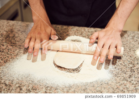 Close up shot of pizzaiolo making dough for Pizza Close up shot of pizzaiolo making dough for Pizza 69851909