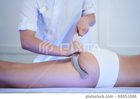 Therapist massaging female buttocks at the spa Therapist massaging female buttocks at the spa 69852806