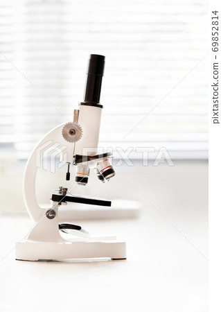 microscope instrument near to the window in the lab 69852814