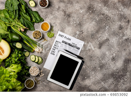 Diet plan concept. Healthy food set Tablet computer with blank screen and weight loss program. Top view. 69853092